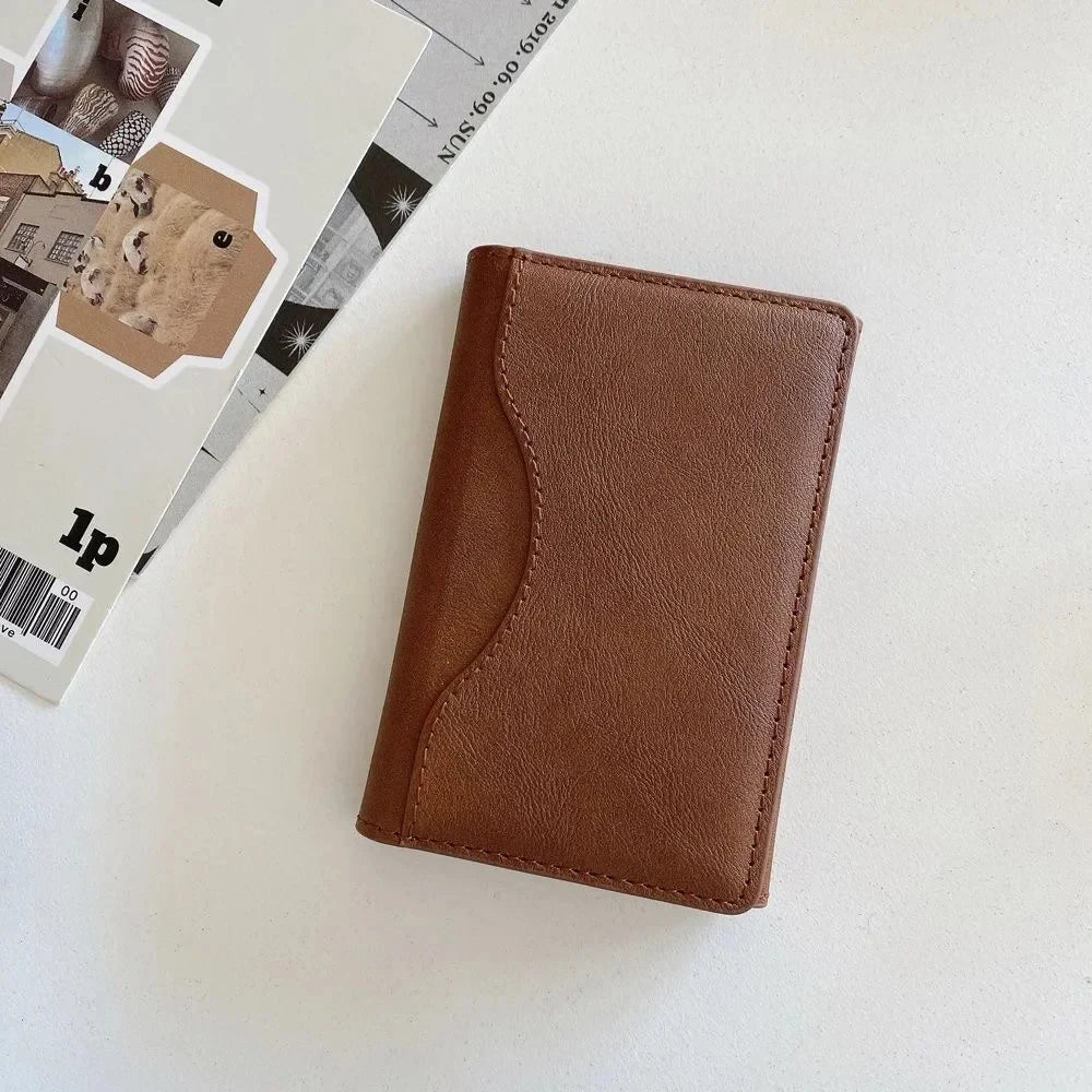 MagSafe leather wallet case for iPhone Pro Max in brown leather-style finish on a flat surface.