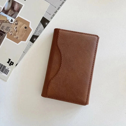 MagSafe leather wallet case for iPhone Pro Max in brown leather-style finish on a flat surface.